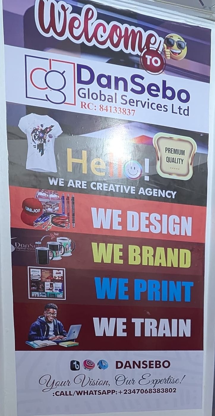 A DanSebo roll-up banner: We Design, We Brand, We Print, We Train