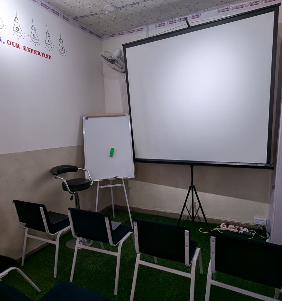 DanSebo training room with projector screen and flip chart