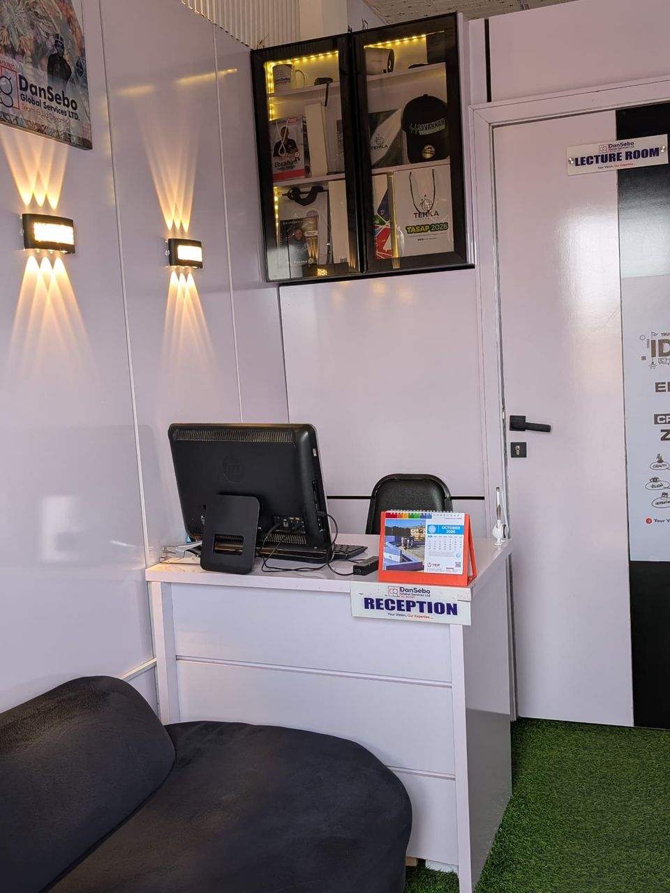 DanSebo reception with a lit display of branded products